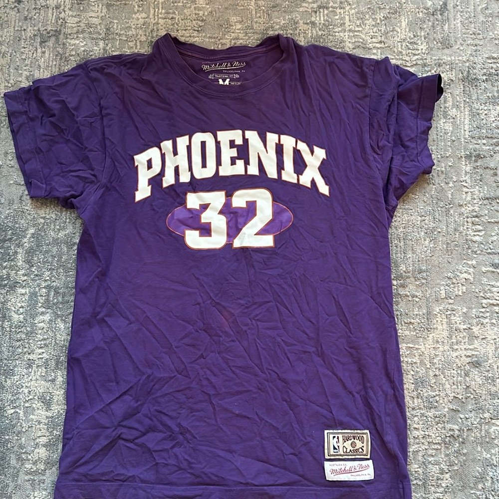 Shaquille O’Neal, Phoenix Suns jersey shirt. purple orange and white.